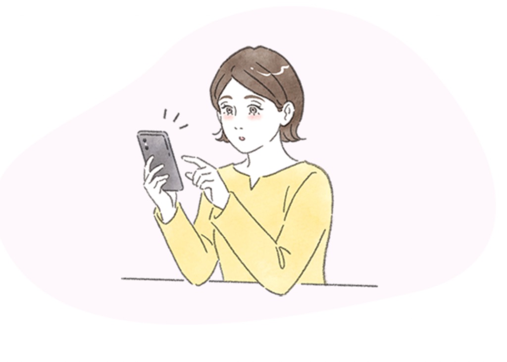 スマートフォンで予約する女性