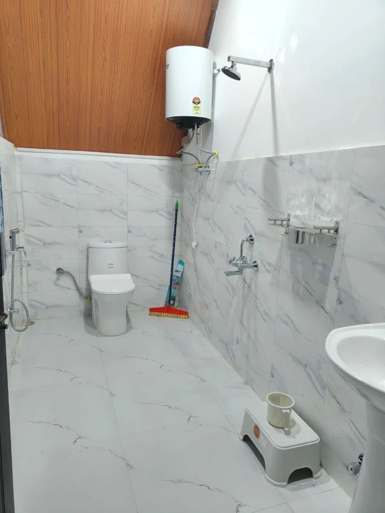 Modern bathroom with marble tiles and 24x7 hot water geyser facility