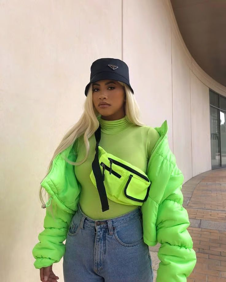 Neon green puffer jacket with black fanny pack street style