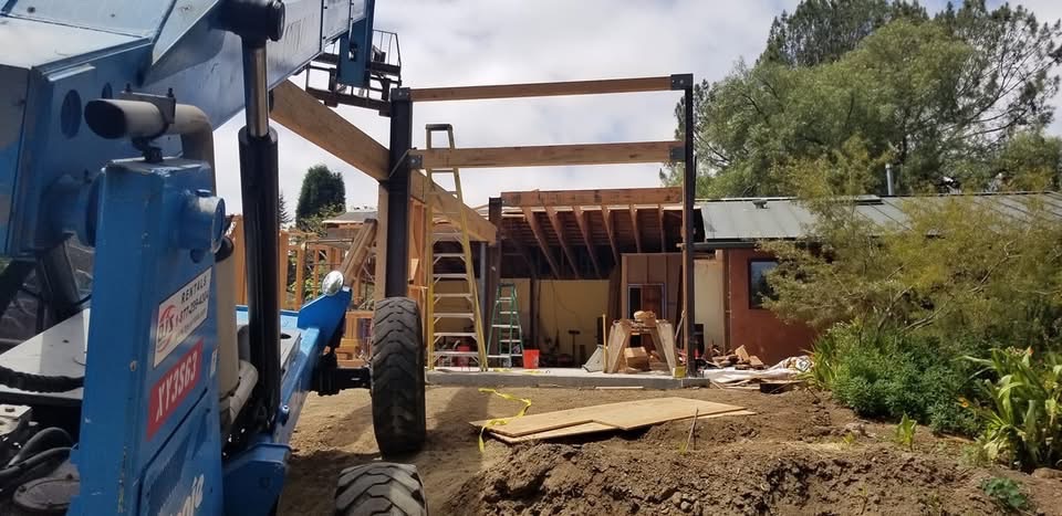 Home addition construction progress showing structural work