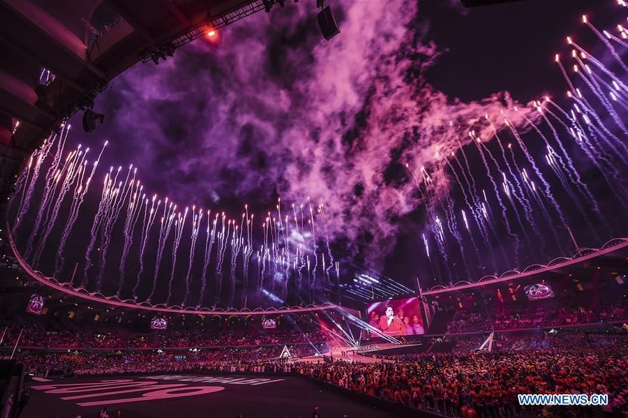 Spectacular purple fireworks display over Special Olympics opening ceremony at packed stadium
