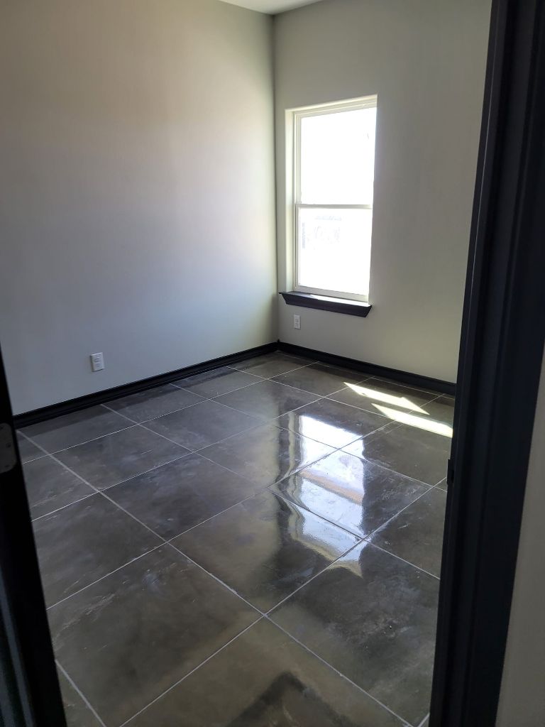 Empty room with polished gray tiles