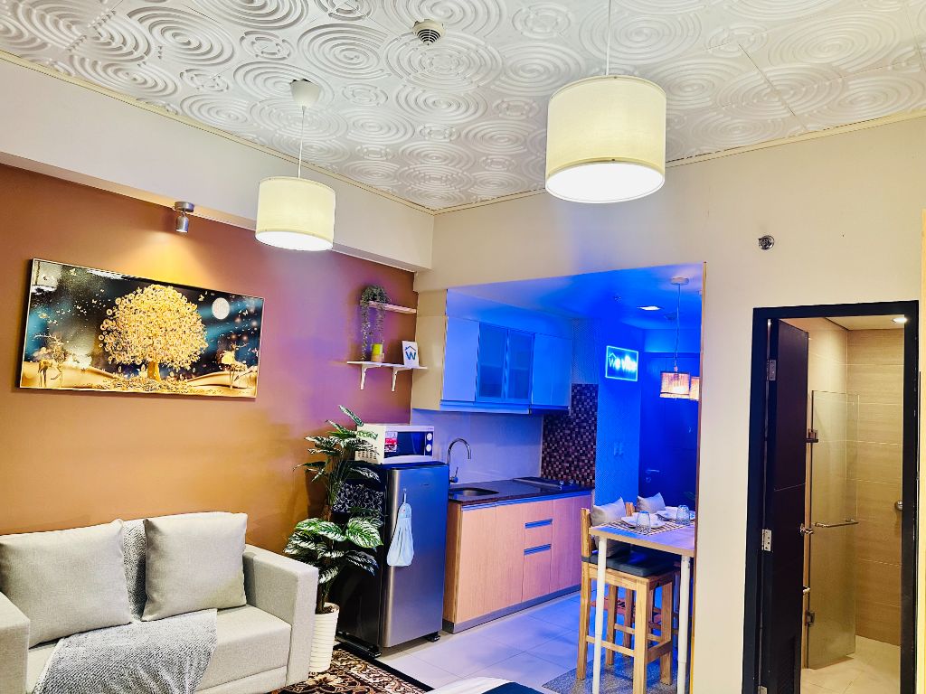 101 Newport Blvd modern kitchen and living area with blue accent lighting and comfortable seating