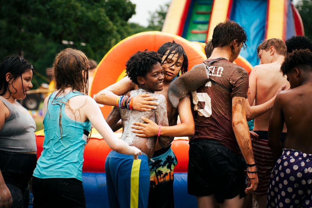 Young people enjoying outdoor activities with inflatable structures in criminal justice program