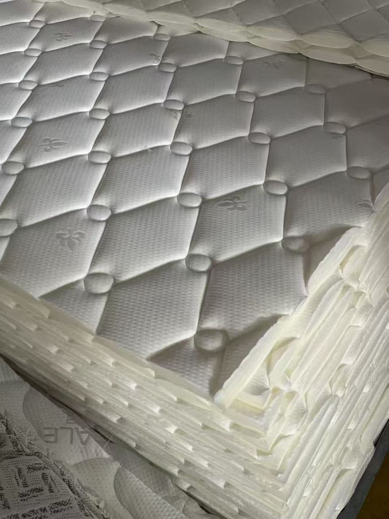 High-quality quilted mattress tops showing precision diamond pattern from Infinity mattress quilting machines