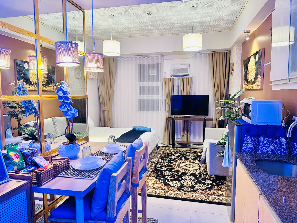 101 Newport Blvd elegant studio with modern dining area, comfortable living space, and stylish blue accents