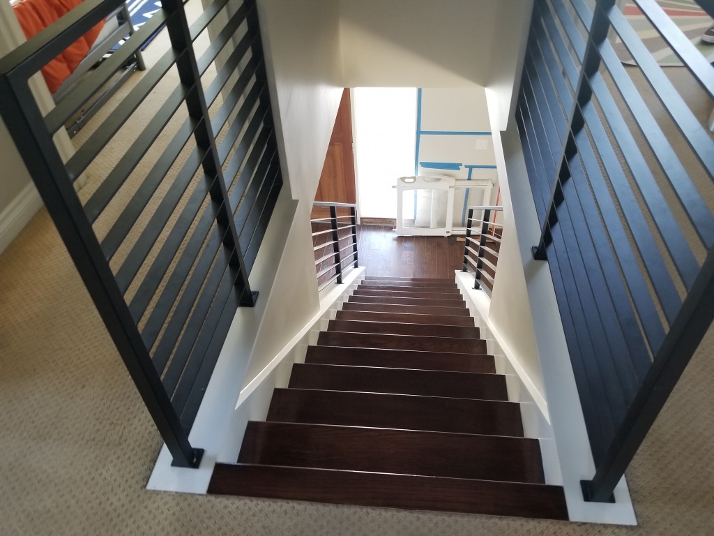 Contemporary staircase transformation with modern steel railings