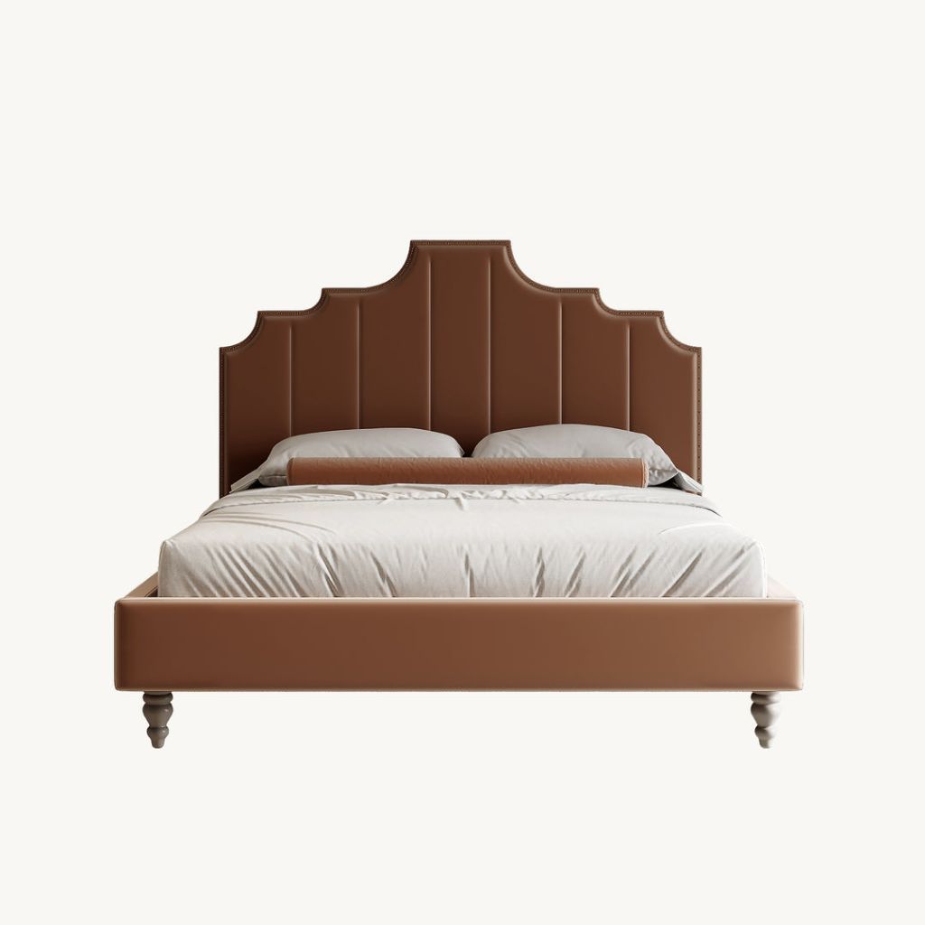 Cognac leather bed with sculpted headboard and bolster pillow