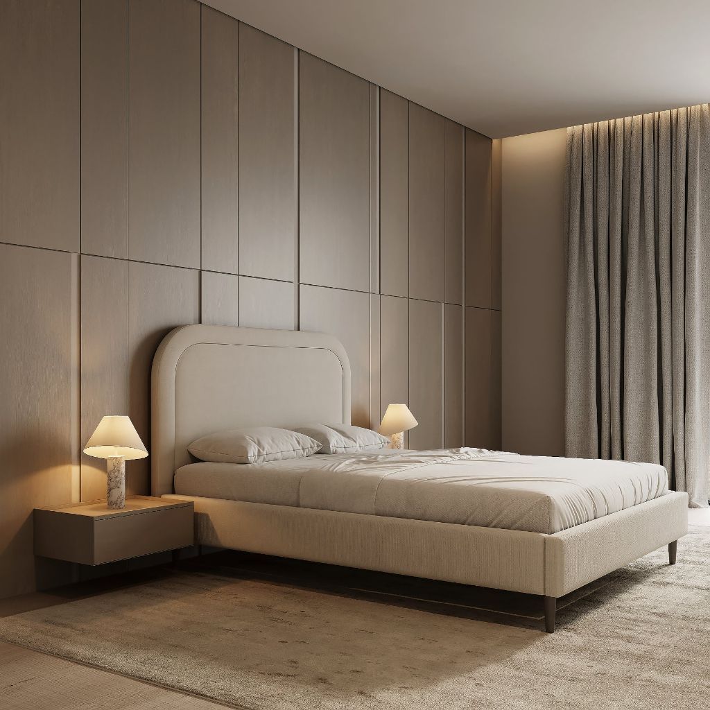 Rounded headboard bed styled in a warm neutral bedroom with soft lighting