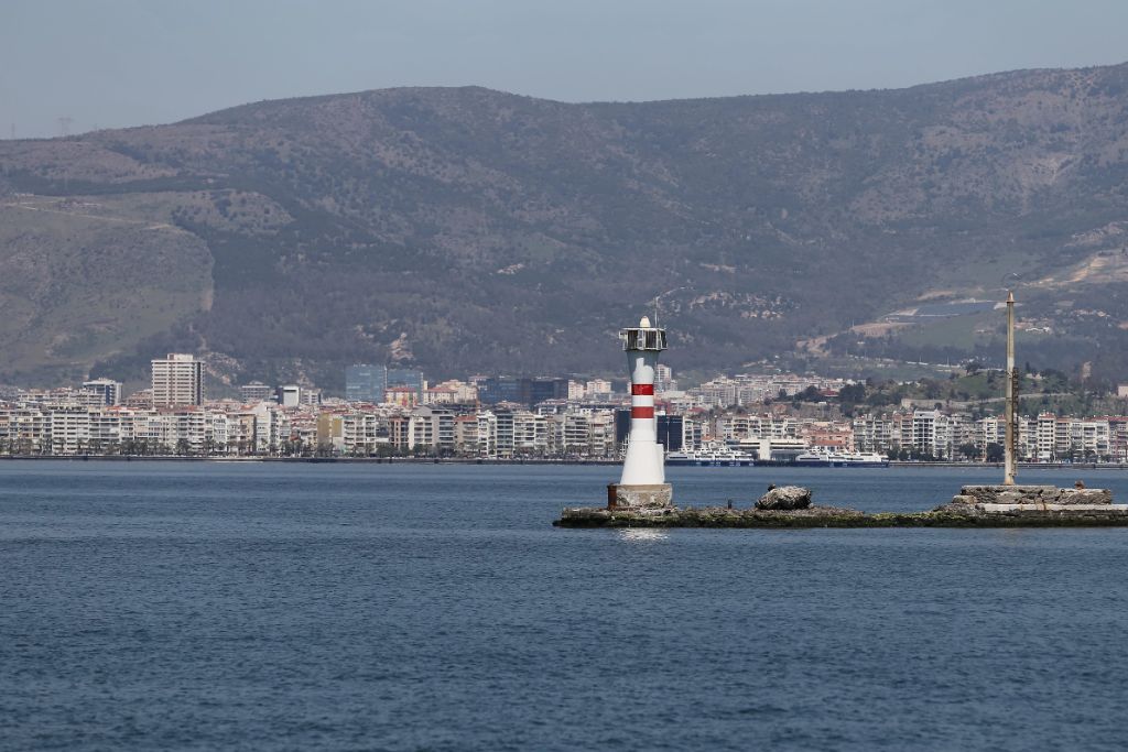 Bulgarian lighthouse and harbor with mountain backdrop