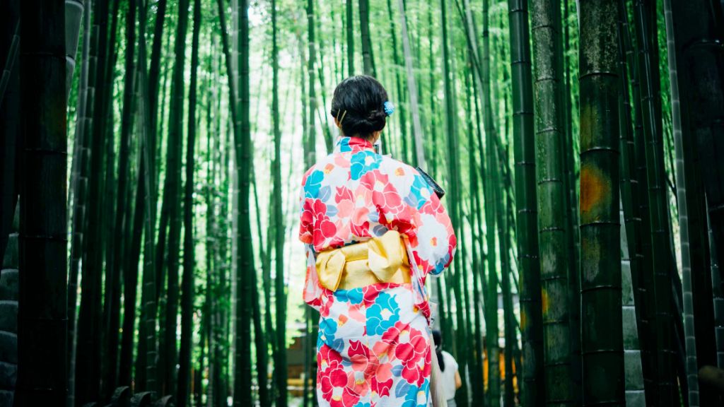 Traditional kimono in bamboo forest setting, showcasing the harmony between Japanese fashion and nature