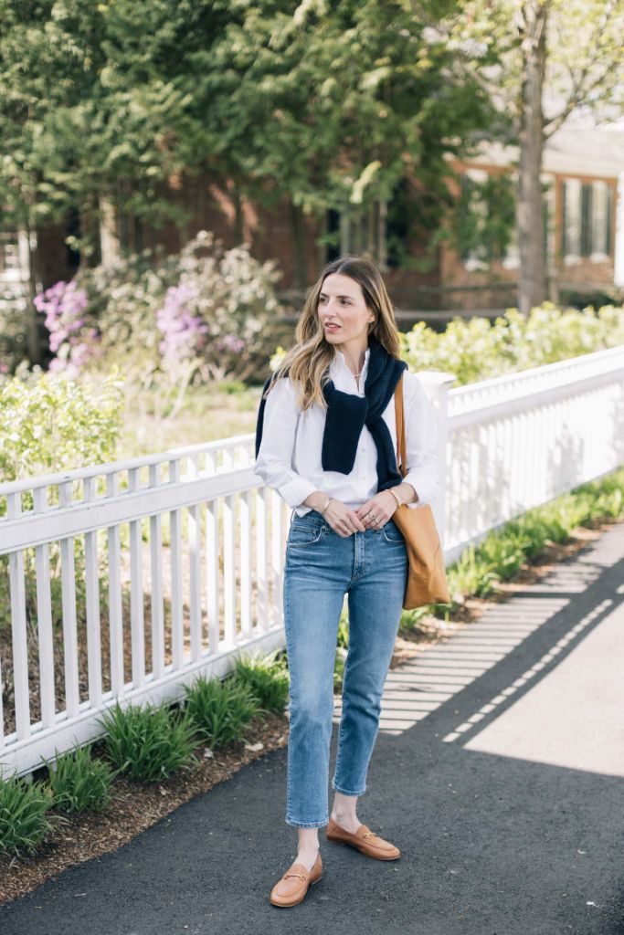 Navy sweater vest over white shirt with jeans preppy style