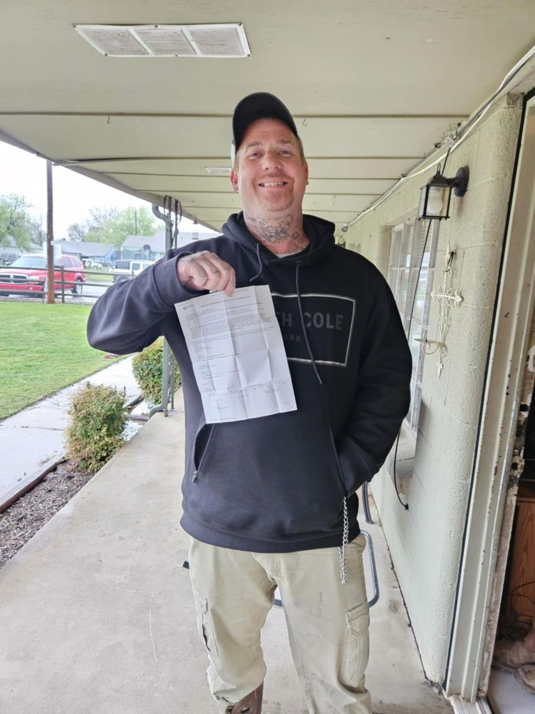 Individual celebrating an achievement with official documentation from criminal justice program