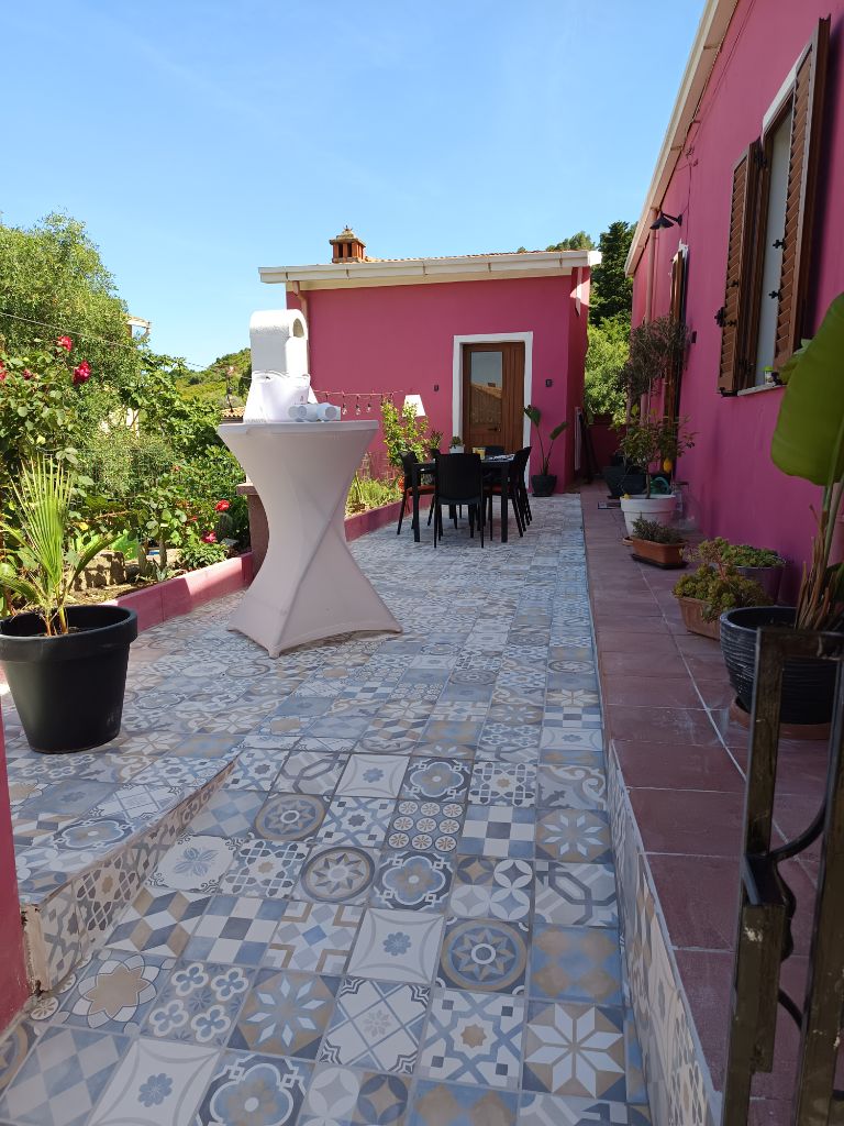 Terrasse mit bunten Mosaikfliesen und Stehtisch