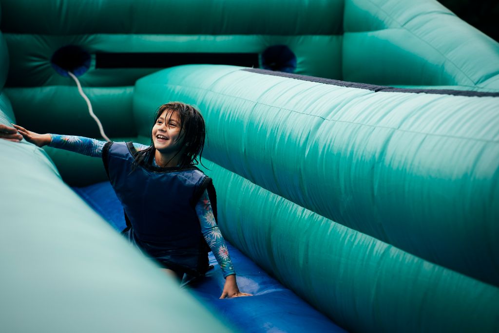 New Day Camp 2025 - Child participating in outdoor activities and obstacle courses