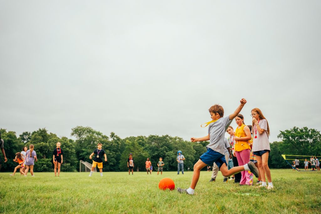 Children playing ball games during New Day Camp outdoor activities for criminal justice families