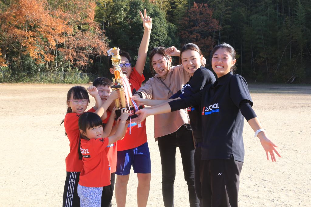 スポーツ鬼ごっこ大会 - トロフィーを掲げて喜ぶ参加者たち