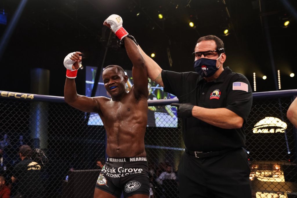 Shawn Bunch celebrating MMA victory - hand raised in triumph showing the results of mental toughness and wrestling mentality