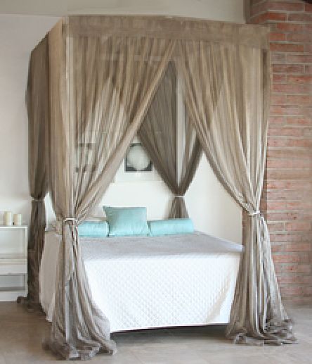 Elegant beige EMF protection bed canopy with four-poster frame showing premium shielding fabric, modern bedroom installation with soft lighting