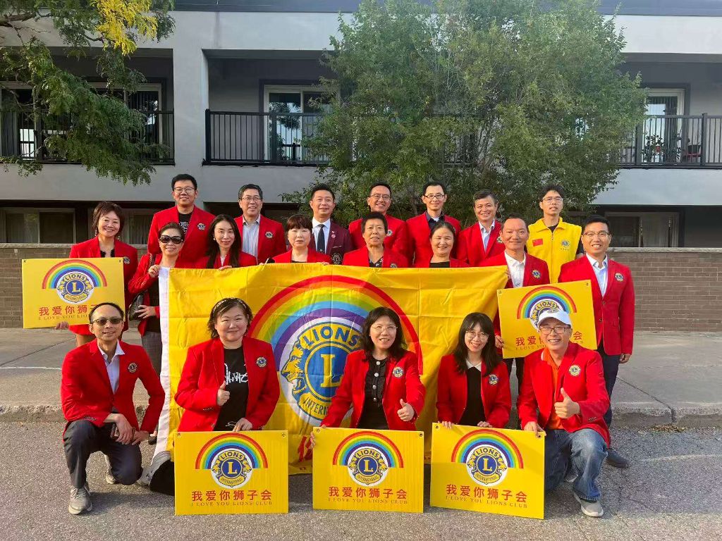 Lions Club team gathering with flags and banners