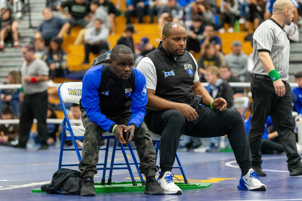 Gym strength training session showing Olympic-level coaching techniques