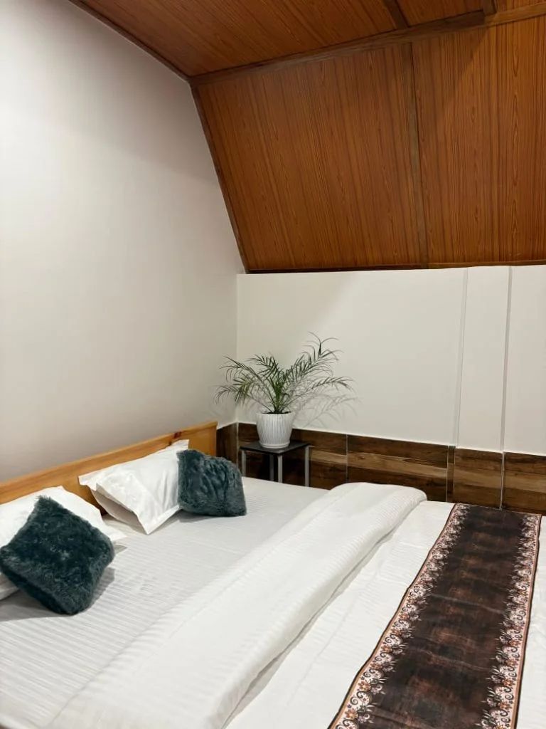 Room interior with three beds and A-frame windows
