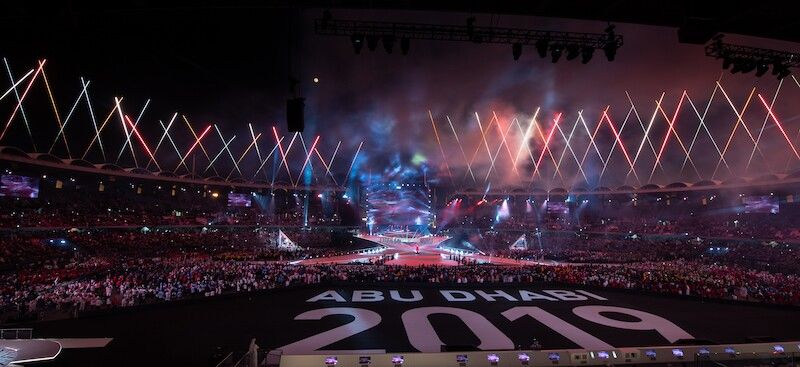 Special Olympics Abu Dhabi 2019 branding on stadium floor with geometric pyrotechnic display