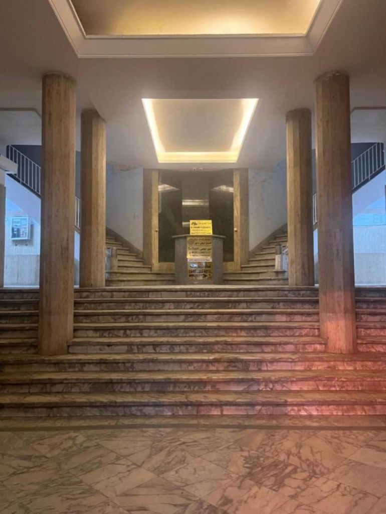 Grand Entrance - Spacious lobby with marble columns and modern lighting
