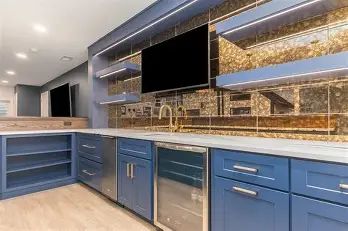Modern kitchen with navy blue cabinets and gold accents