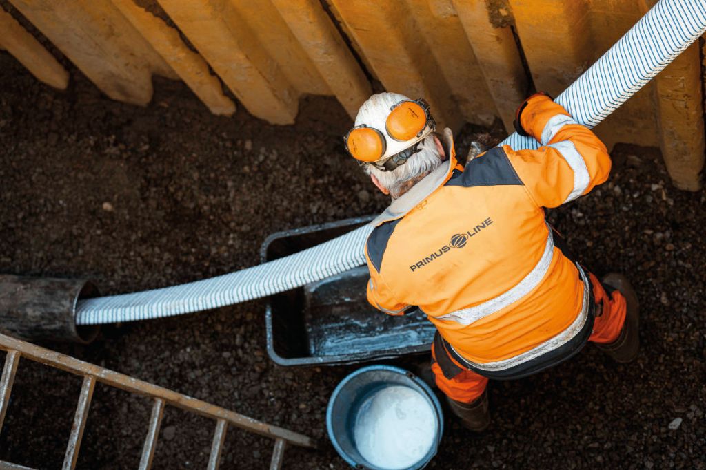 Worker performing sliplining installation