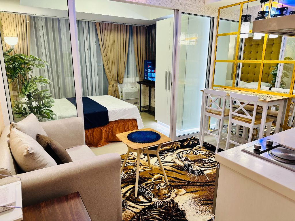 Azure Urban Resort condo interior with modern living space, dining area, and city view